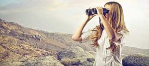 beautiful woman looking through binoculars