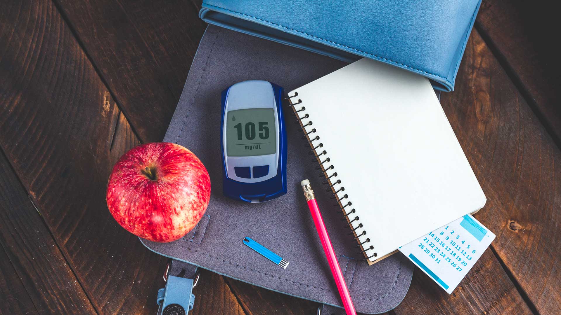 Diabetes concept. Control diabetes, monitor blood glucose levels, self control. Write blood glucose readings in the diary of self-control