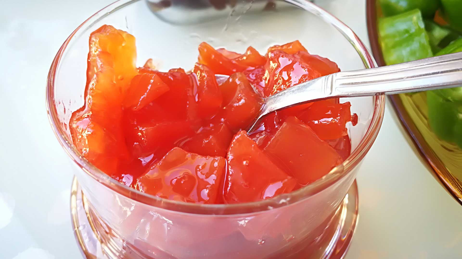 Quince Jam and a spoon in a Glass Bowl