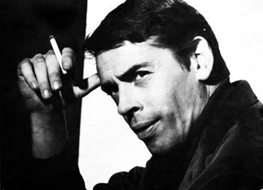 Black and white photo of Jacques Brel holding a cigarette