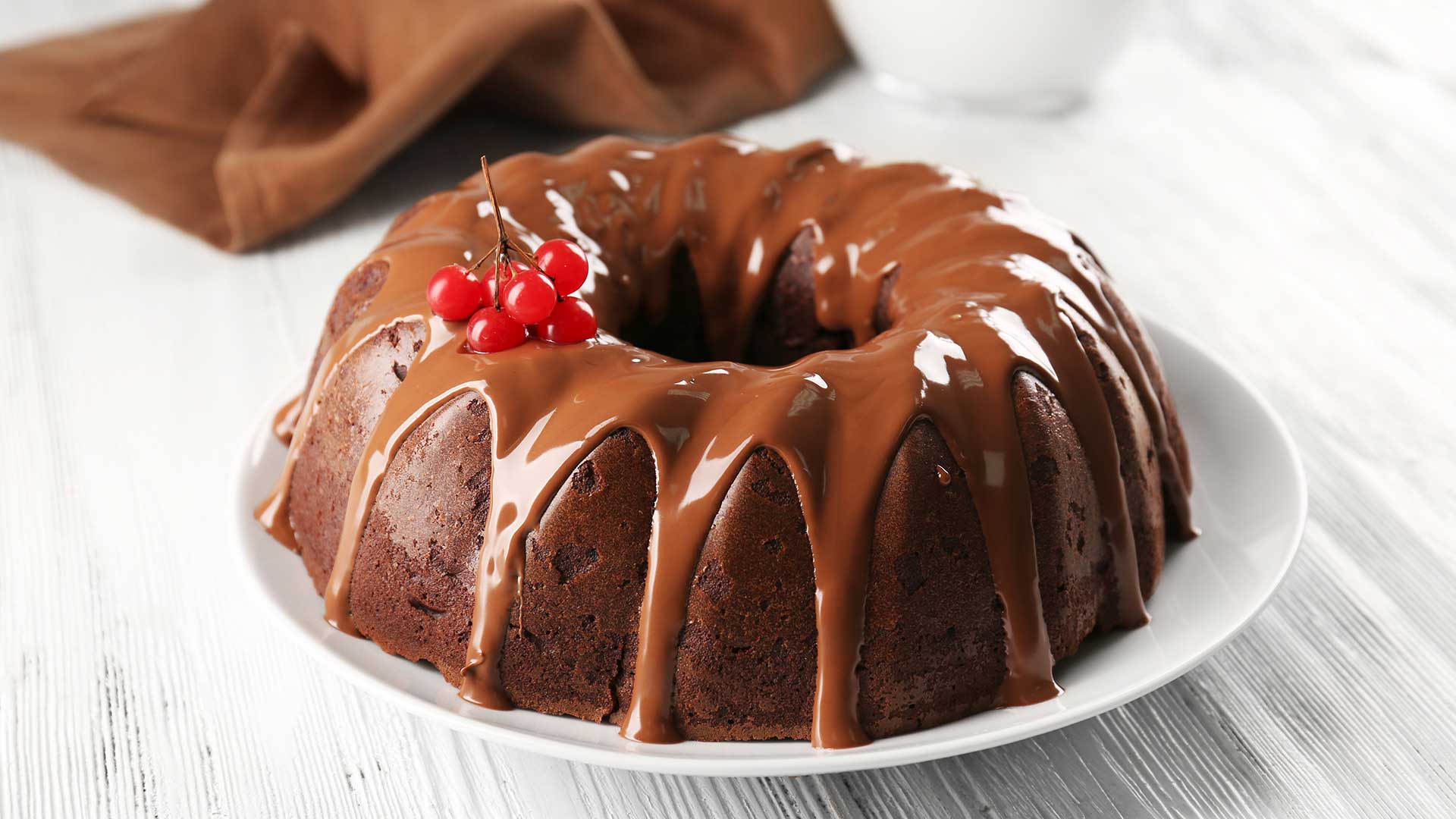 Chocolate cake with a bottle of milk on a table