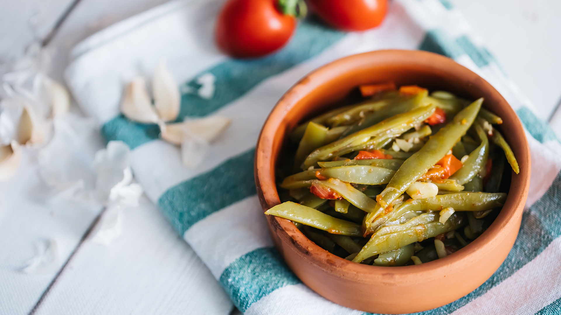 Turkish traditional Fresh Beans food casserole in bowl. Green beans olive oil whiteboard on the floor