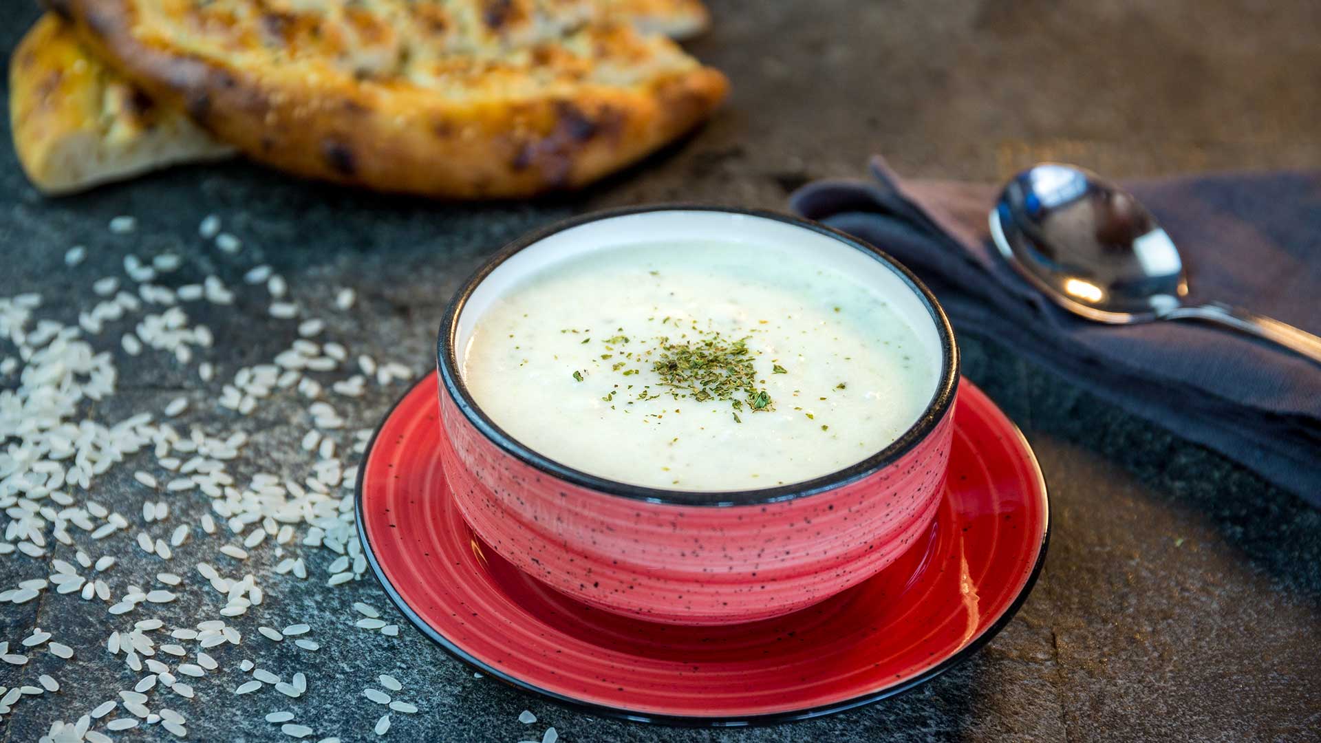 Turkish yoghurt soup in red bowl