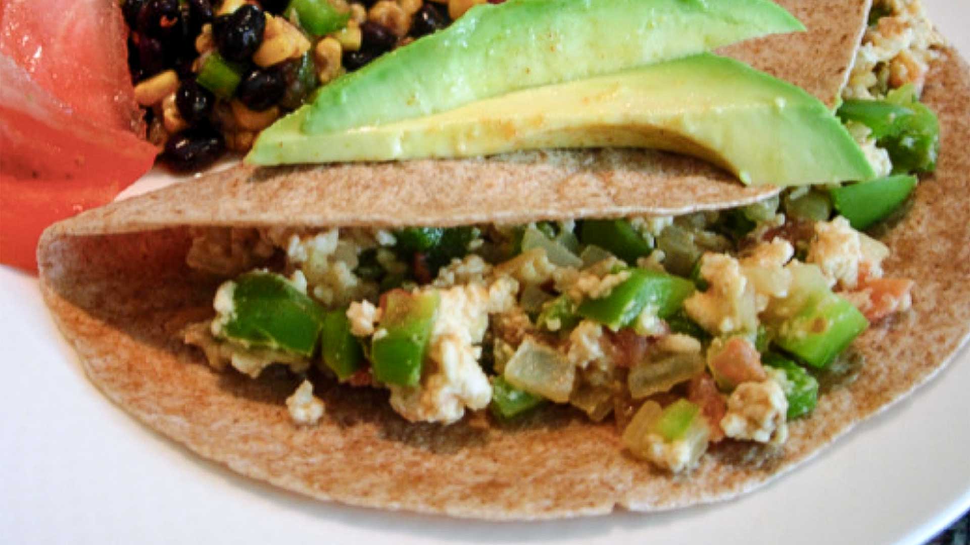 Egg salad in wheat tortilla with avocado on top