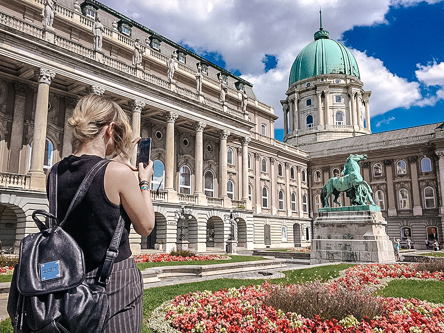 Tourist taking photos of Royal Palace, Budapest