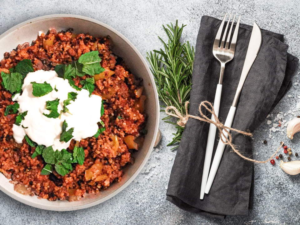 Bulgur pilaf on plate with decorated dinner table