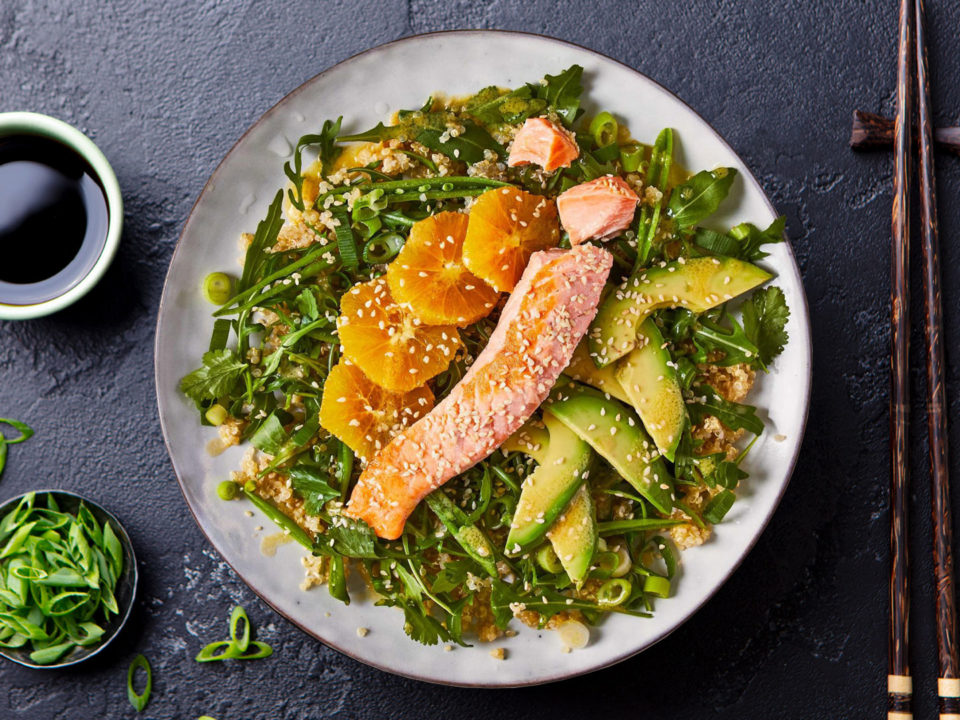 salmon salad with orange on black table top