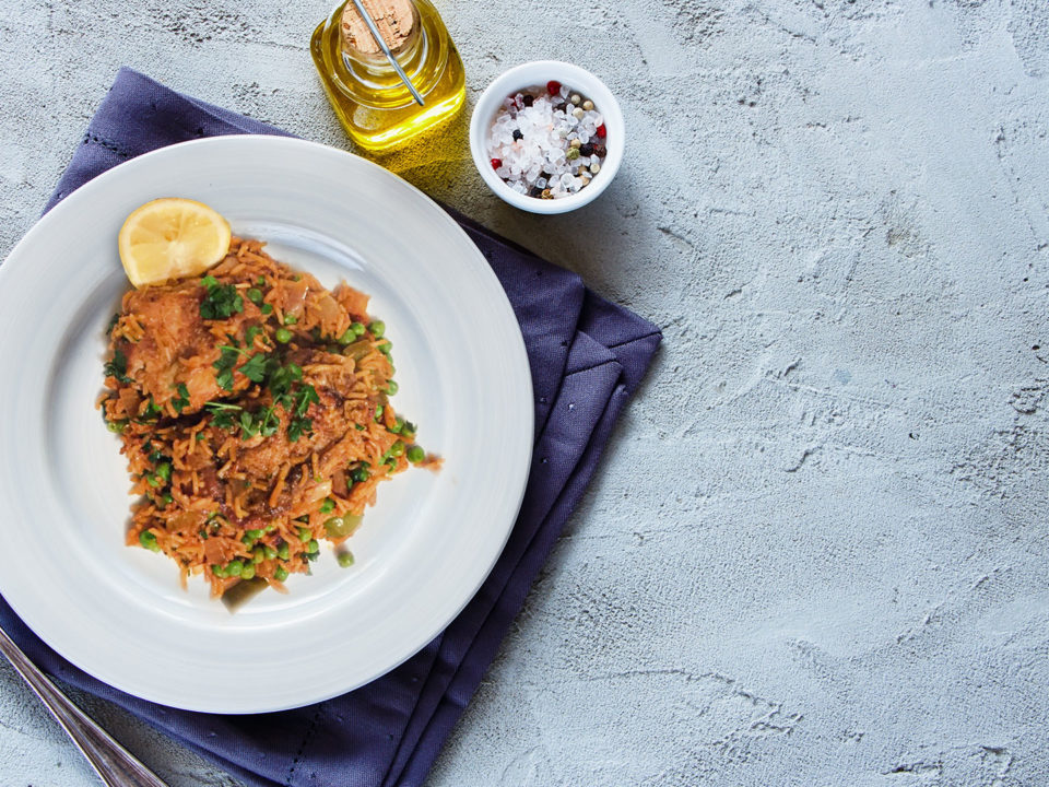 One-Pot-Brazilian Chicken & Saffron Rice on a white plate on dinner table